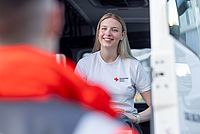 Junge Dame der Bereitschaften steht lächelnd im LKW